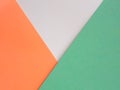 Abstract minimalistic tricolor background. White, orange and green paper in triangular and polygon shape