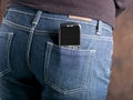 Abstract mobile phone in the back pocket of jeans Royalty Free Stock Photo