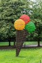 Abstract modern art, ice cream cone sculpture in a park. Royalty Free Stock Photo