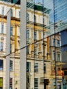 Reflection of historical houses on modern glass building in Vienna, abstract urban texture