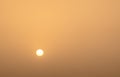 Abstract monochrome minimalistic image of the sun in front of a yellow sky, background