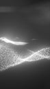 Abstract monochrome visualization of glowing white particles forming dynamic flowing waves on a dark background Royalty Free Stock Photo