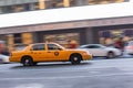 Abstract motion blur of a city street scene with a yellow taxi cabs Royalty Free Stock Photo