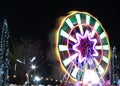 Abstract moving light from ferris wheel at night time. Movement Ferris wheel at amusement carousel. Royalty Free Stock Photo