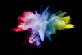 Abstract multi color powder explosion on black background. Royalty Free Stock Photo