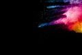 Abstract multi color powder explosion on black background.  Freeze motion of color dust  particles splash Royalty Free Stock Photo