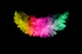 Abstract multi color powder explosion on black background.