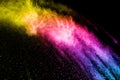 Abstract multi color powder explosion on black background. Royalty Free Stock Photo