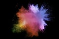 Abstract multi color powder explosion on black background. Freeze motion of color dust particles splash. Painted Holi Royalty Free Stock Photo