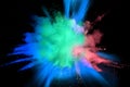 Abstract multi color powder explosion on black background. Royalty Free Stock Photo