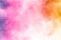 Abstract multi color powder explosion on white background.