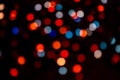 Abstract multicolor bokeh texture on black background.