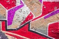 Abstract multicolored graffiti drawings. Wall painting Lilac, red and beige. Cement background with texture