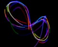 Abstract multicolored lines drawn by light on a black background Royalty Free Stock Photo