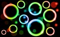 Abstract, multicolored, neon, shiny, bright, glowing circles, balls, bubbles, light spots with stars on a black background.