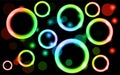 Abstract, multicolored, neon, shiny, bright, glowing circles, balls, bubbles, light spots with stars on a black background. Royalty Free Stock Photo