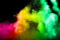 Abstract multicolored powder splatted on black background Royalty Free Stock Photo