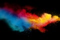 Abstract multicolored powder splatter on black background