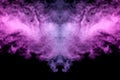 Abstract mystical bat silhouette straightened wings and head from streams of colorful smoke evaporating from a vape illuminated by Royalty Free Stock Photo