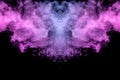 Abstract mystical bat silhouette straightened wings from streams of colorful smoke evaporating from a vape illuminated by neon Royalty Free Stock Photo