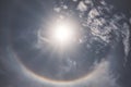 Natural phenomenal of midday sparkling sun ray rainbow orbit in the blue cloud sky Royalty Free Stock Photo