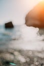 Abstract nature summer ocean sunset sea background. Small waves on water surface in motion blur with bokeh lights from Royalty Free Stock Photo