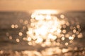 Abstract nature summer ocean sunset sea background. Small waves on water surface in motion blur with bokeh lights from Royalty Free Stock Photo