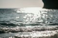 Abstract nature summer ocean sunset sea background. Small waves on water surface in motion blur with bokeh lights from Royalty Free Stock Photo