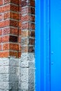 Close up macro of bricks and blue painted wall