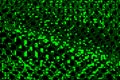 Abstract net texture of green ascii symbols, letters and pixels on black background