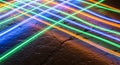 Abstract network of colorful light streaks crossing over a textured, cracked surface background Royalty Free Stock Photo