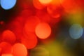Abstract background of bright glittering lights, Christmas red blue yellow holiday bokeh Royalty Free Stock Photo