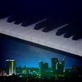 Abstract night background with city and piano keys Royalty Free Stock Photo