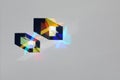 Abstract object from the lights of the spectrum and shadow in the refraction of sunlight on the surface of the paper on a gray Royalty Free Stock Photo