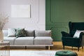 Abstract oil painting on grey wall with moldings in contemporary living room interior with grey long couch Royalty Free Stock Photo