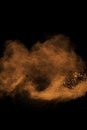 Abstract orange dust explosion on black background. Royalty Free Stock Photo