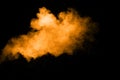 Abstract orange dust explosion on  black background.  Freeze motion of orange powder clouds splash Royalty Free Stock Photo
