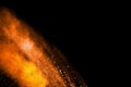 Abstract orange powder explosion on black  background. Freeze motion of orange  dust particles splash Royalty Free Stock Photo