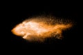 Abstract orange powder explosion on black  background. Freeze motion of orange dust particles splash Royalty Free Stock Photo