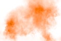 Abstract orange powder explosion on  white background. Freeze motion of orange dust splash Royalty Free Stock Photo