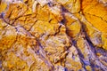 Abstract orange yellow blue background. Colorful rock texture. Cracked layered mountain surface. Royalty Free Stock Photo