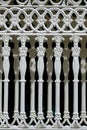 Abstract ornament decorative pattern of vintage white cast iron sliding fence gate in Roman style and vertical frame Royalty Free Stock Photo