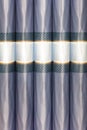 Abstract ornament of fabric lilac curtains rolled into tubes in the interior of the wall Royalty Free Stock Photo