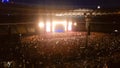 Abstract out of focus image of illuminated scene with lasers and colorful light beams on rock concert at night