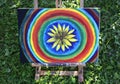 Abstract painting on canvas on easel in summer park. Royalty Free Stock Photo