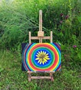 Abstract painting on canvas on easel in the summer park. Royalty Free Stock Photo