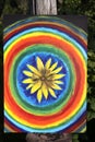 Abstract painting on canvas in the summer park. Yellow rudbeckia flower and rainbow circles. Royalty Free Stock Photo