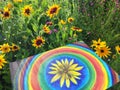 Abstract painting on canvas in the summer park. Yellow rudbeckia flower and rainbow circles. Royalty Free Stock Photo