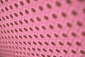 Abstract pale pink perforated surface of weave threads