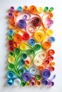 Abstract panel made of colored paper scrolled into curls and rolls. Quilling banner on a white background with copy space.